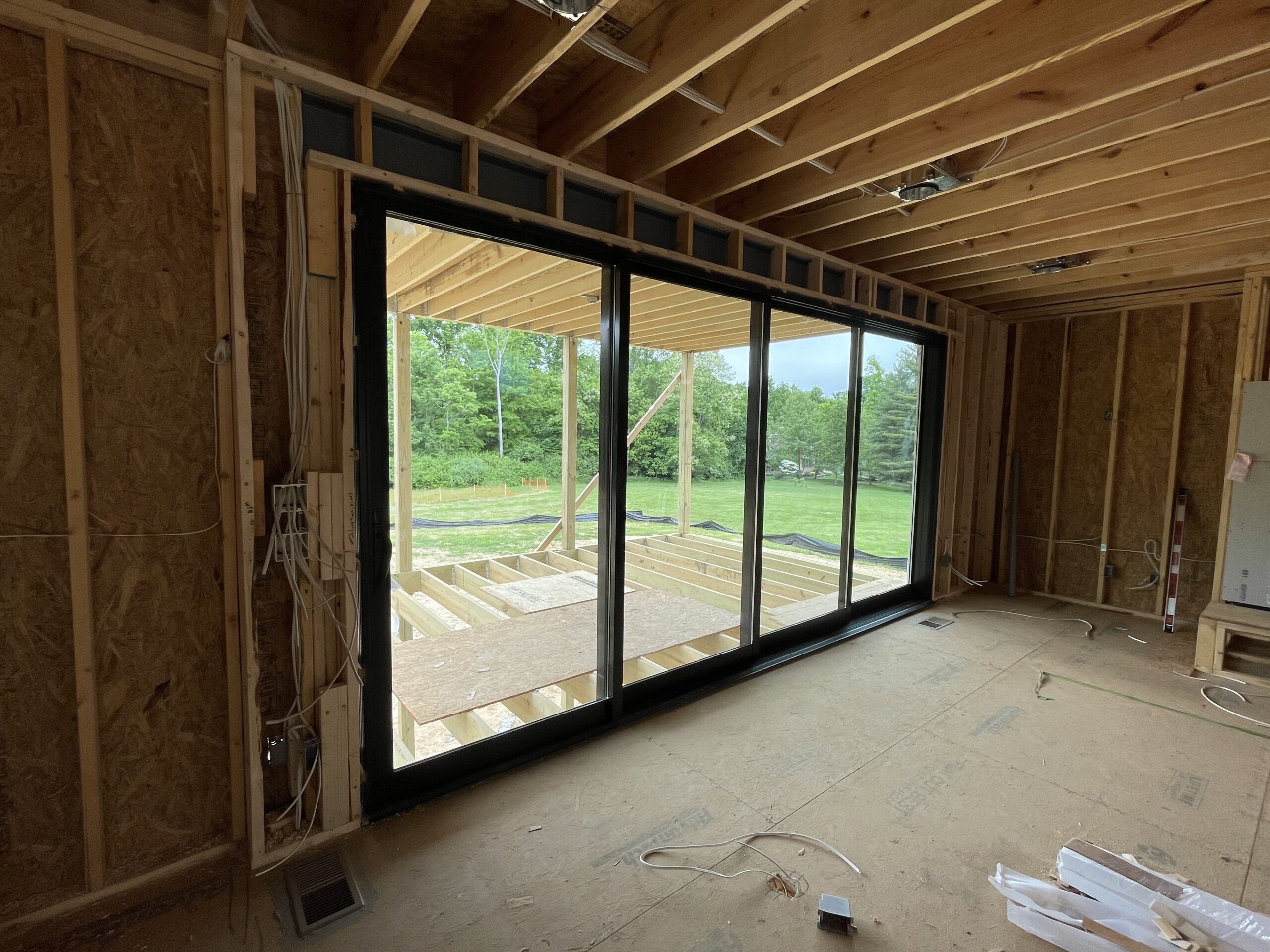 view of four glass panel doors from inside a home under construction